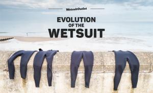 Wetsuits hanging on a sea wall