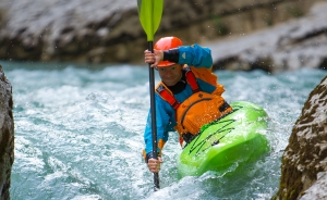 Man kayaking down rapids