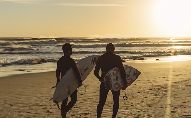 surfers and a sunset
